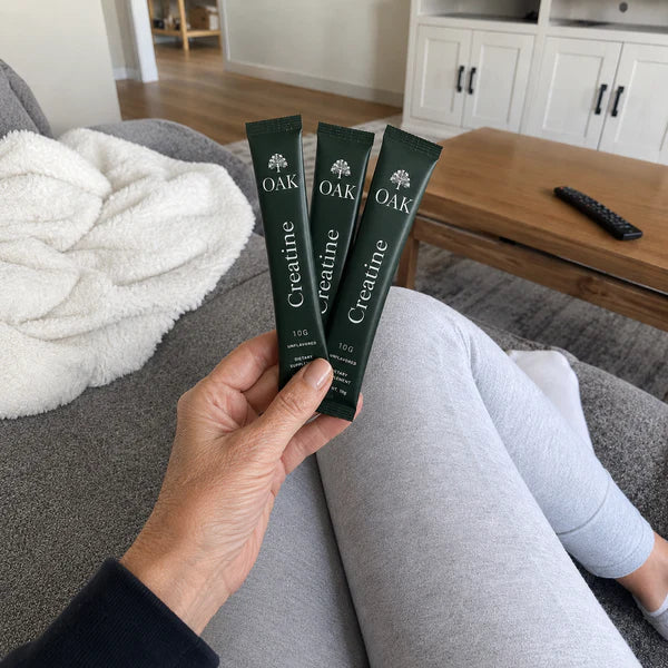 Holding three sticks on the sofa